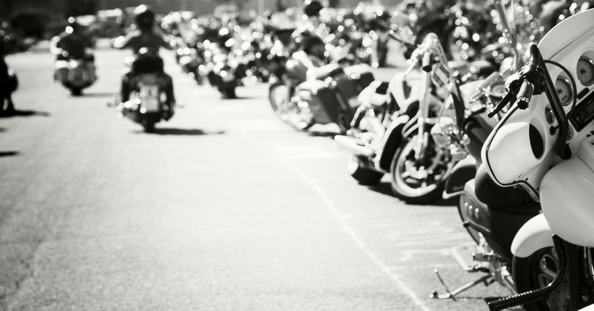 group of motorcycles and riders in black and white